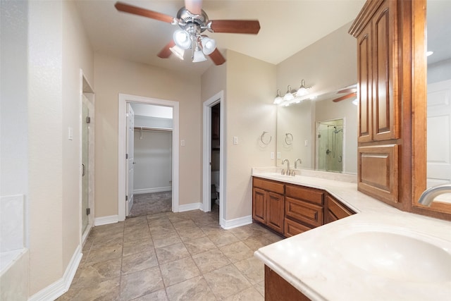 bathroom featuring vanity, a shower with shower door, and ceiling fan