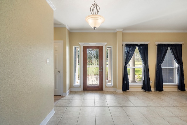 tiled entryway featuring crown molding