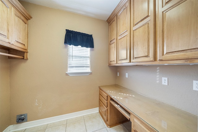 interior space with cabinets and light tile patterned floors