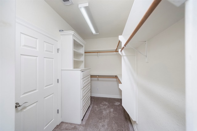 spacious closet featuring dark carpet