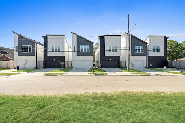 view of front of home featuring a garage and a front yard