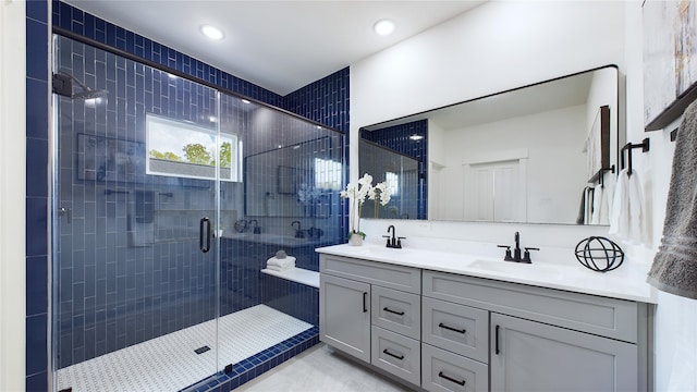 bathroom featuring vanity, a shower with shower door, and tile patterned floors