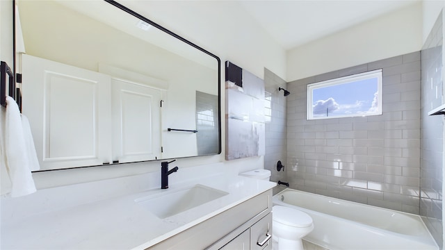 full bathroom featuring vanity, toilet, and tiled shower / bath