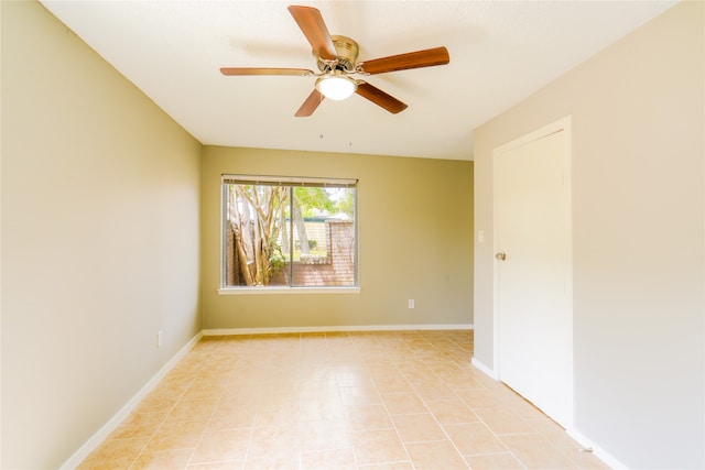 tiled empty room featuring ceiling fan