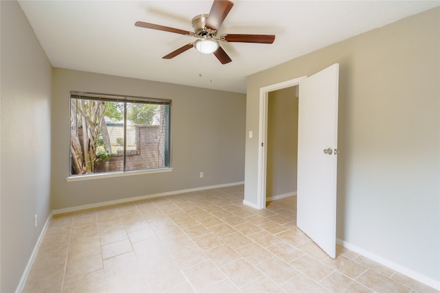 unfurnished room with ceiling fan and light tile patterned floors