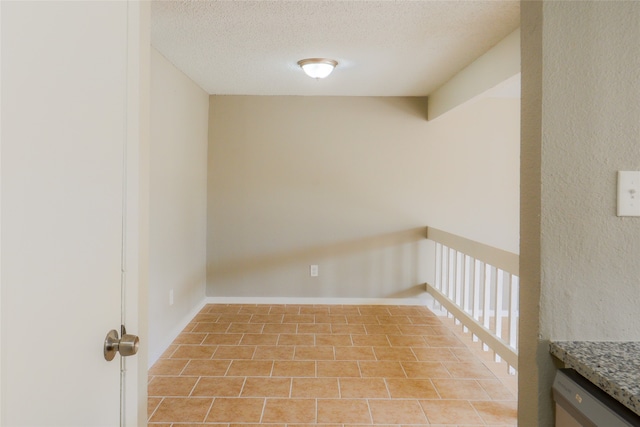 spare room with a textured ceiling