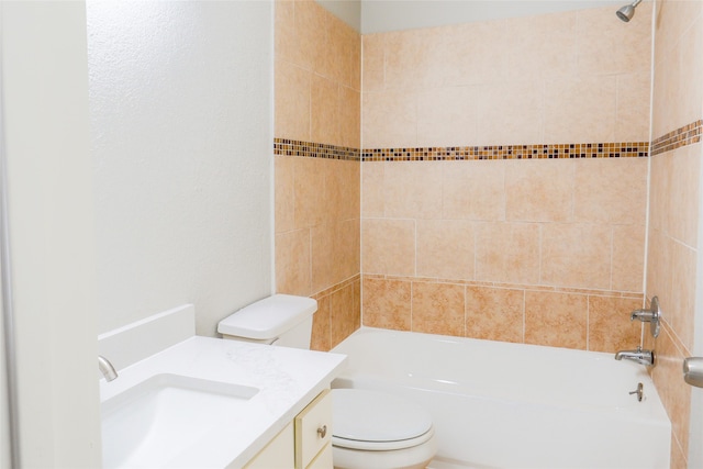 full bathroom featuring toilet, tiled shower / bath, and vanity