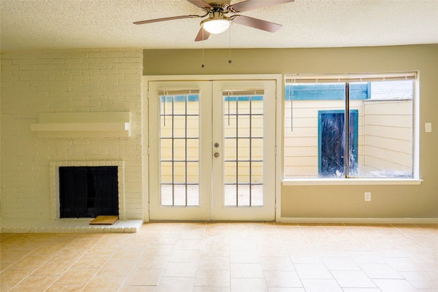 doorway to outside featuring french doors, light tile patterned flooring, a textured ceiling, and ceiling fan