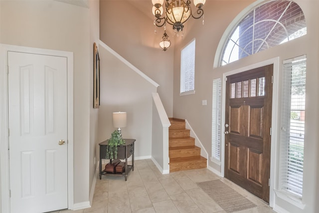 tiled entryway with a notable chandelier