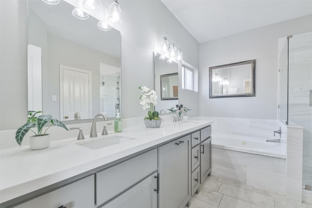 bathroom featuring separate shower and tub and vanity