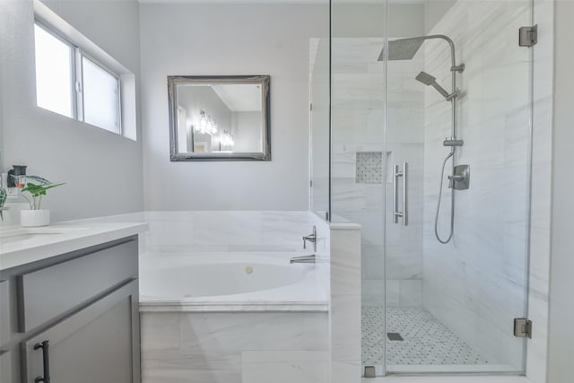 bathroom with vanity and independent shower and bath