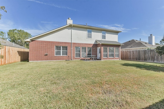 rear view of house with a yard