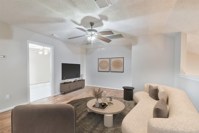 living room featuring light hardwood / wood-style floors and a textured ceiling