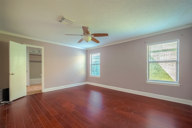 empty room featuring ceiling fan, a textured ceiling, plenty of natural light, and dark hardwood / wood-style floors