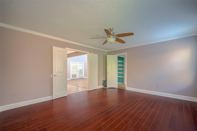 empty room featuring crown molding, dark hardwood / wood-style floors, a textured ceiling, and ceiling fan