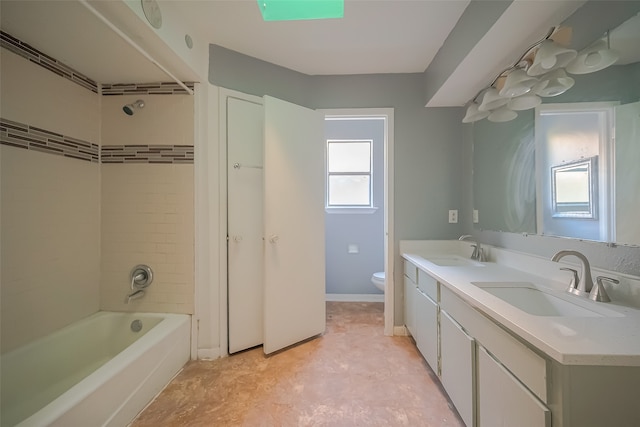 full bathroom featuring toilet, tiled shower / bath combo, and vanity