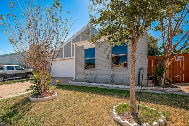 view of front facade with a front lawn and a garage