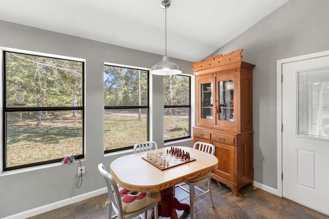 dining space featuring lofted ceiling