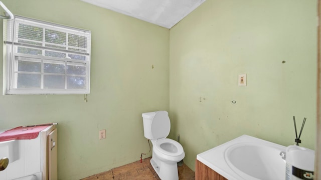 bathroom with vanity, toilet, and ornamental molding