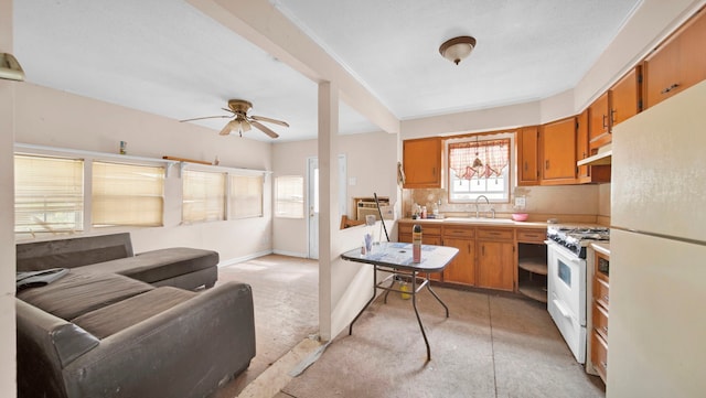 kitchen with ceiling fan, white appliances, and sink