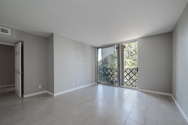 unfurnished room featuring floor to ceiling windows