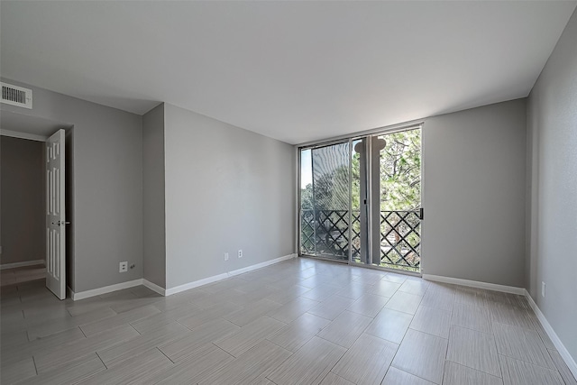 2333 Bering Dr Unit 139, Houston, TX 77057 - unfurnished room with floor to ceiling windows, baseboards, and french doors