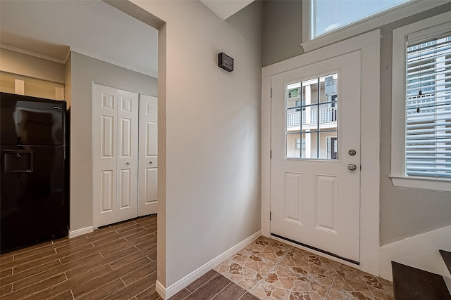 2333 Bering Dr Unit 139, Houston, TX 77057 - doorway featuring healthy amount of natural light, wood finished floors, ornamental molding, and baseboards