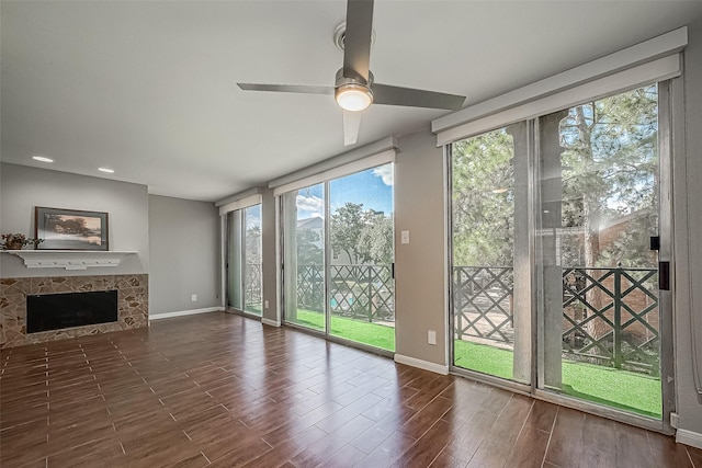 unfurnished living room with a tile fireplace and ceiling fan