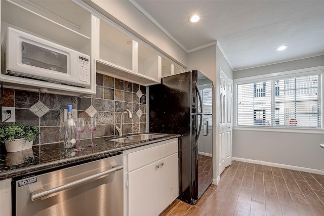 2333 Bering Dr Unit 139, Houston, TX 77057 - kitchen with stainless steel dishwasher, white microwave, light wood-style flooring, white cabinetry, and tasteful backsplash