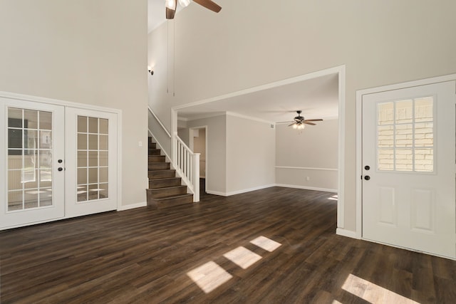 foyer entrance with french doors, ceiling fan, a high ceiling, and dark hardwood / wood-style floors