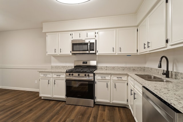 kitchen featuring stainless steel appliances, sink, dark hardwood / wood-style floors, and white cabinets