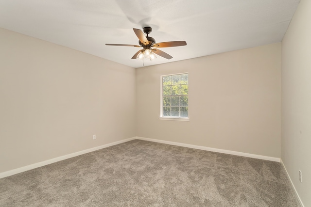 empty room with ceiling fan and carpet