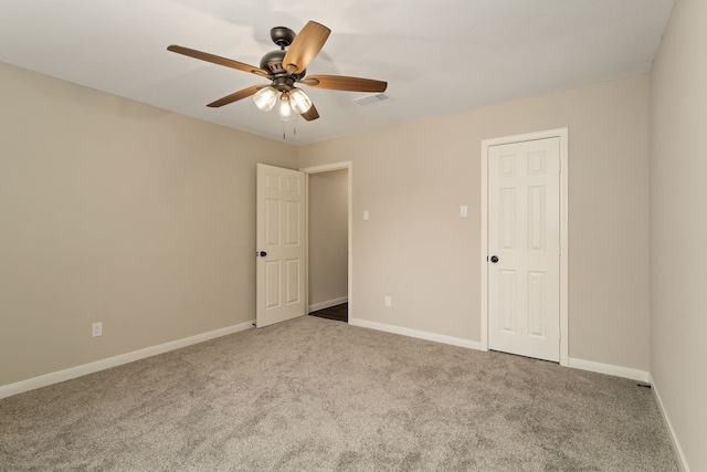 empty room featuring light colored carpet and ceiling fan