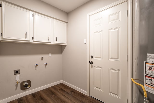 washroom featuring hookup for a gas dryer, electric dryer hookup, dark hardwood / wood-style floors, water heater, and cabinets