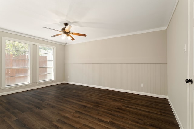 unfurnished room with dark wood-type flooring, ceiling fan, crown molding, and wood walls