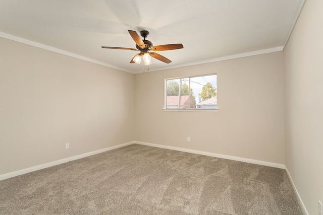 carpeted empty room with ceiling fan and ornamental molding