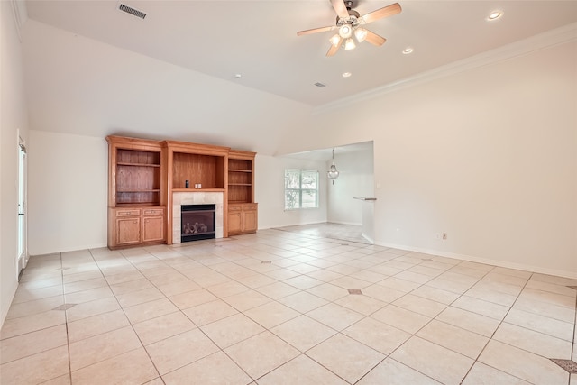 unfurnished living room featuring crown molding, vaulted ceiling, light tile patterned floors, a fireplace, and ceiling fan