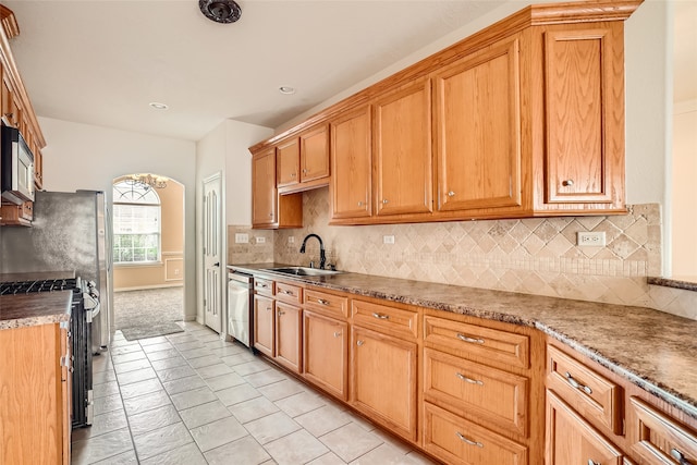 kitchen with decorative backsplash, sink, stainless steel dishwasher, and black gas stove