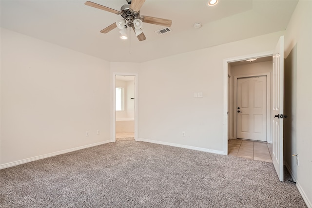 spare room with light carpet and ceiling fan