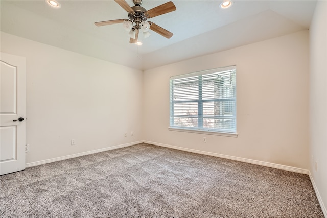 carpeted spare room with ceiling fan