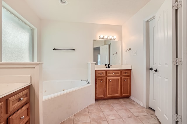 bathroom featuring vanity, a tub to relax in, and tile patterned floors