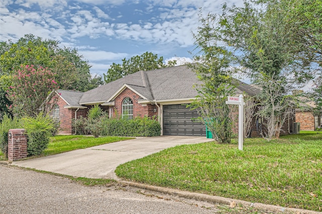 view of front of home with a garage and a front lawn