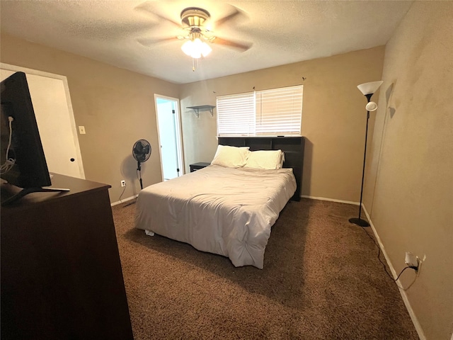 carpeted bedroom featuring a textured ceiling and ceiling fan