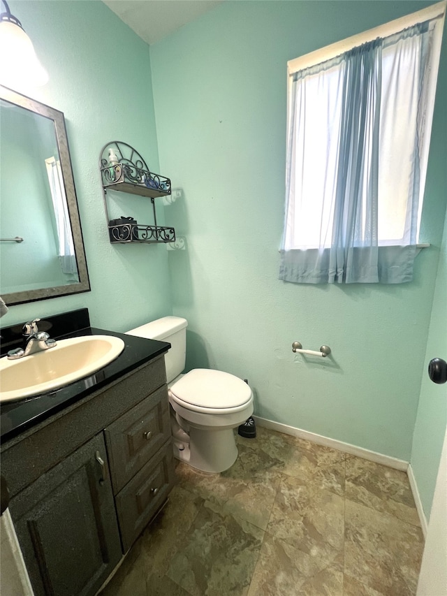 bathroom featuring toilet and vanity