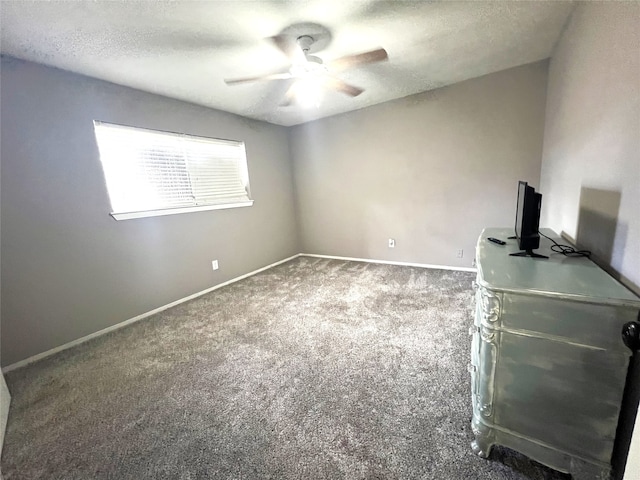 carpeted empty room featuring a textured ceiling and ceiling fan