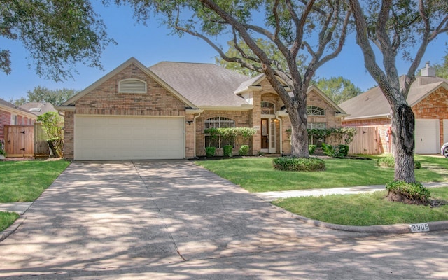 view of front of home featuring a front yard and a garage