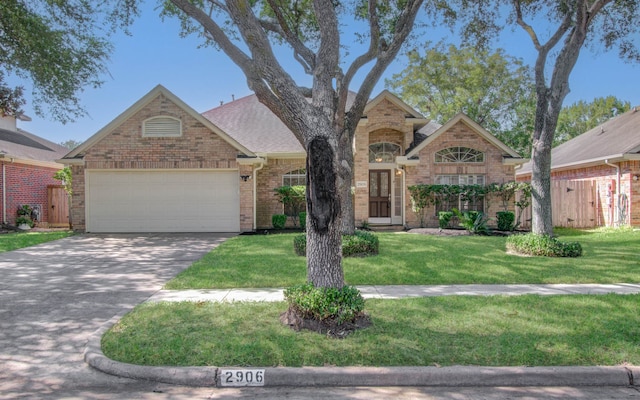 view of property with a front yard and a garage