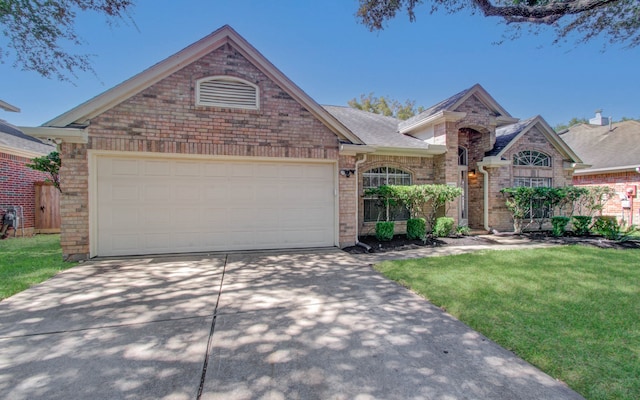 view of front facade featuring a front yard and a garage