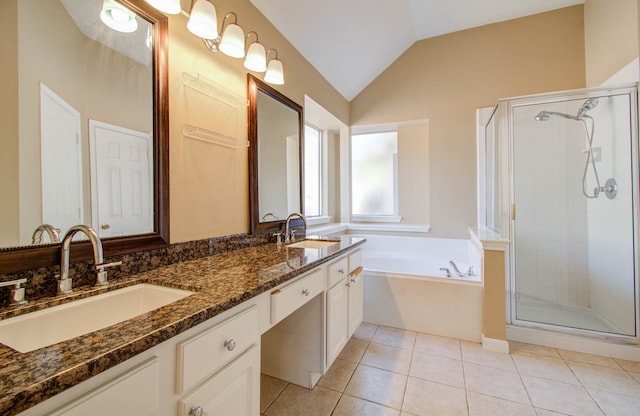 bathroom with vanity, separate shower and tub, vaulted ceiling, and tile patterned flooring