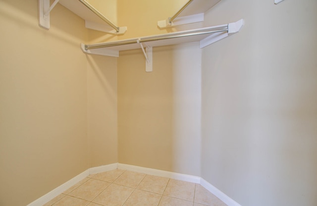 spacious closet featuring light tile patterned floors